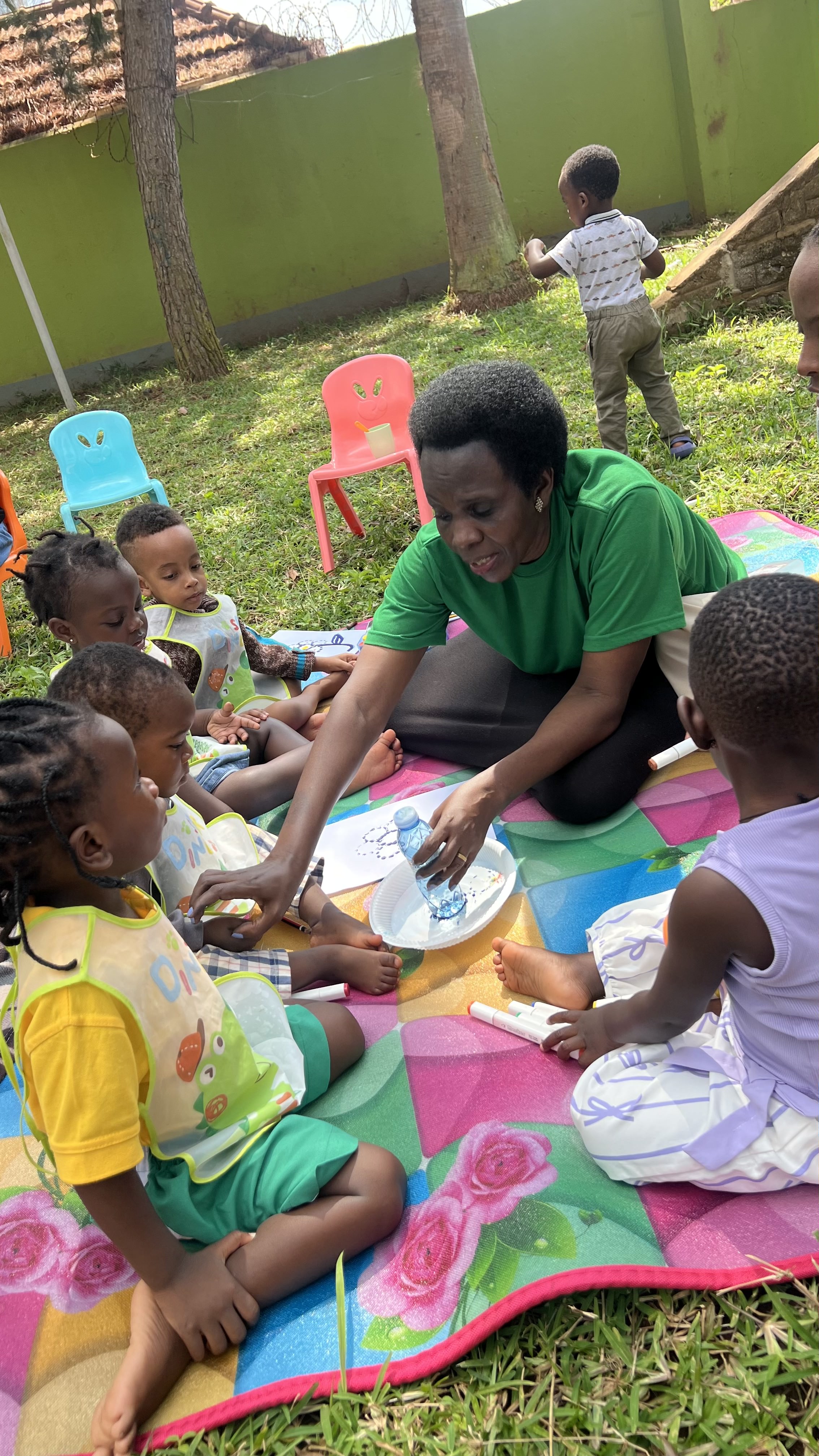 Happy students interacting with teacher at Carezza International School